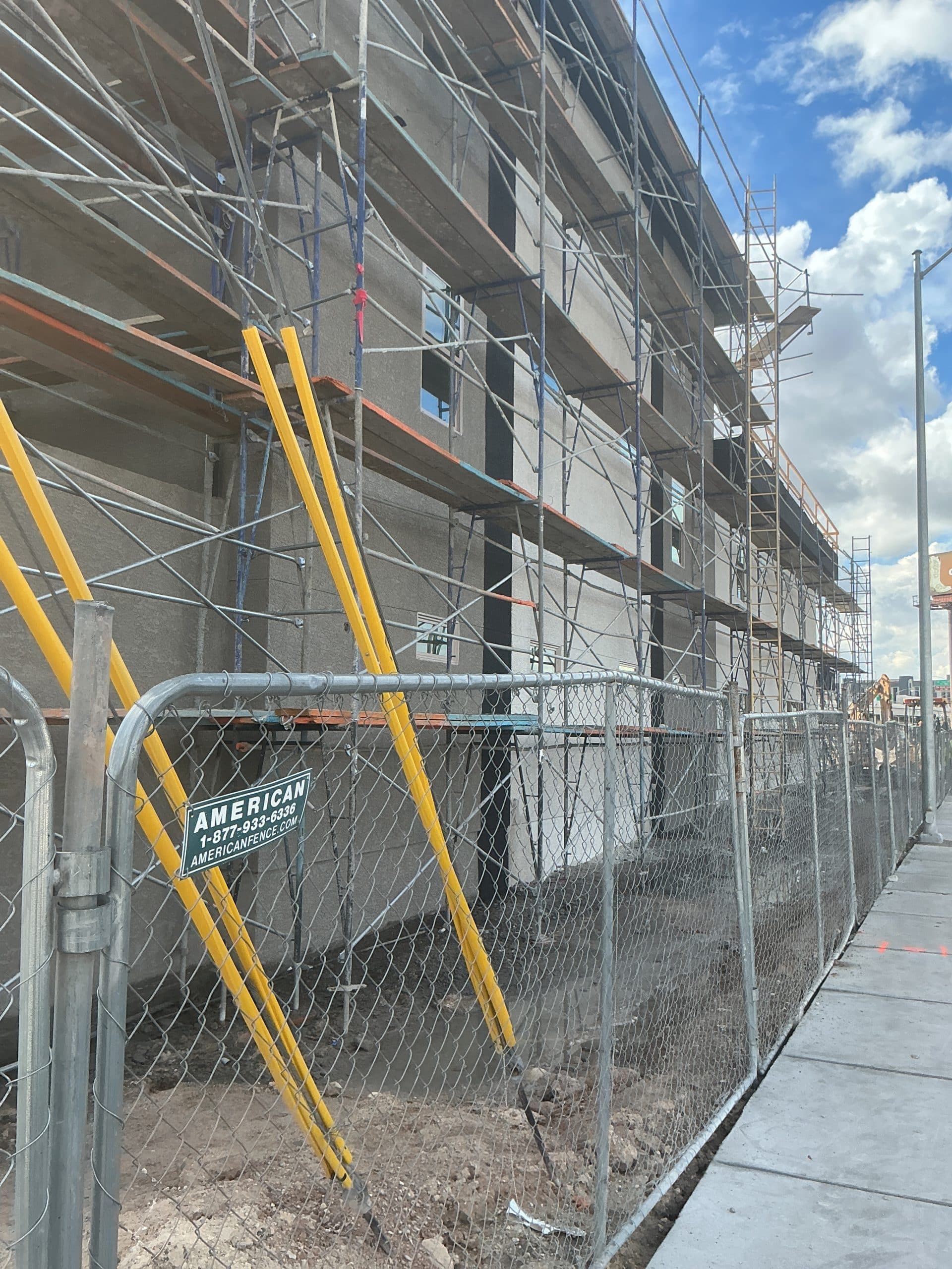Construction site with scaffolding and fence