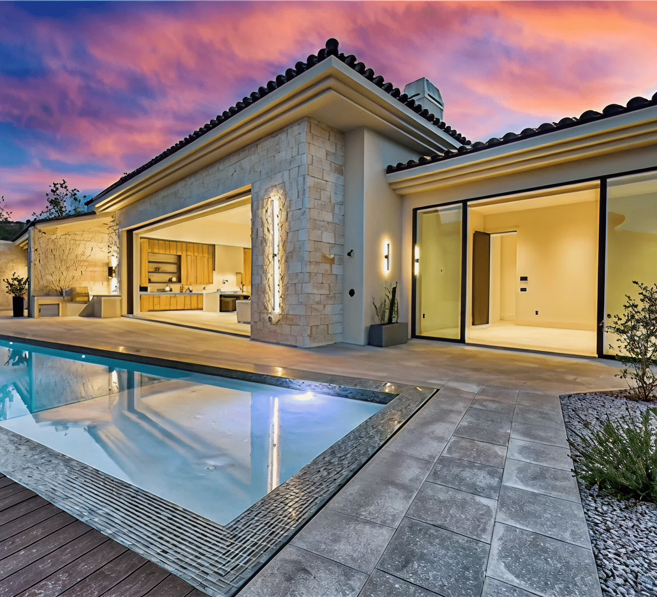 Modern home with pool at sunset