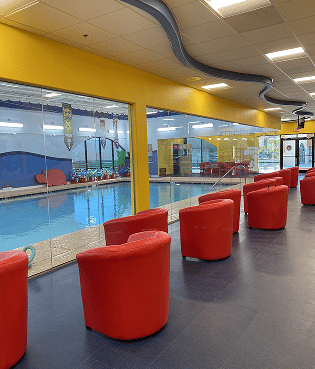 Indoor pool with red seating area